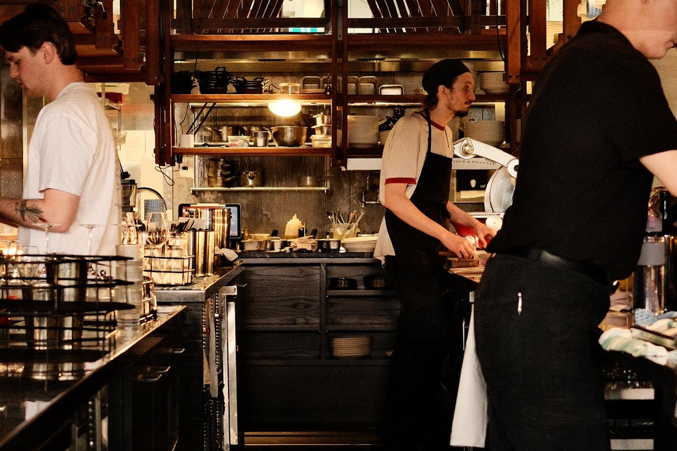 Busy barista station with staff working in a coffee shop.
